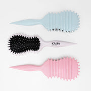 Photo des brosses stylisantes de Kalia Nature, disponibles en trois couleurs.